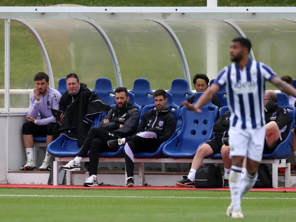 Carlos Corberán and some of his coaching staff watching the game against Bolton 