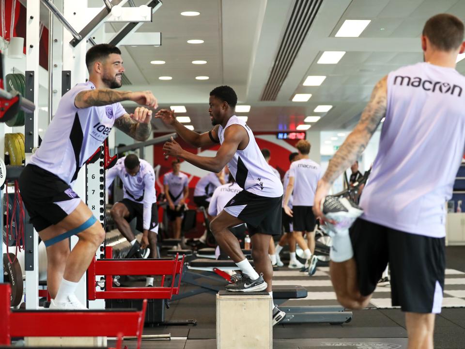 Several players working out in the gym at St. George's Park