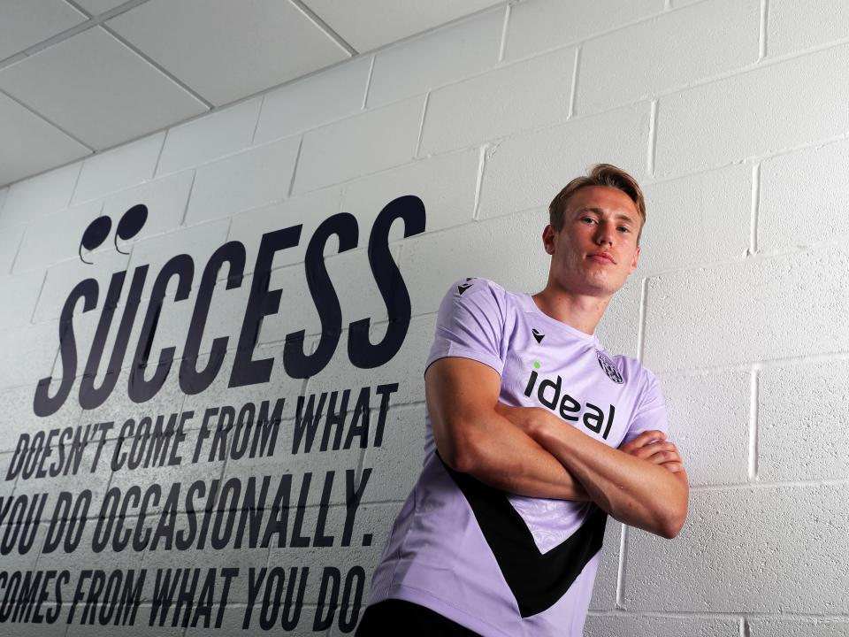 Torbjørn Heggem stood next to a wall with motivational words