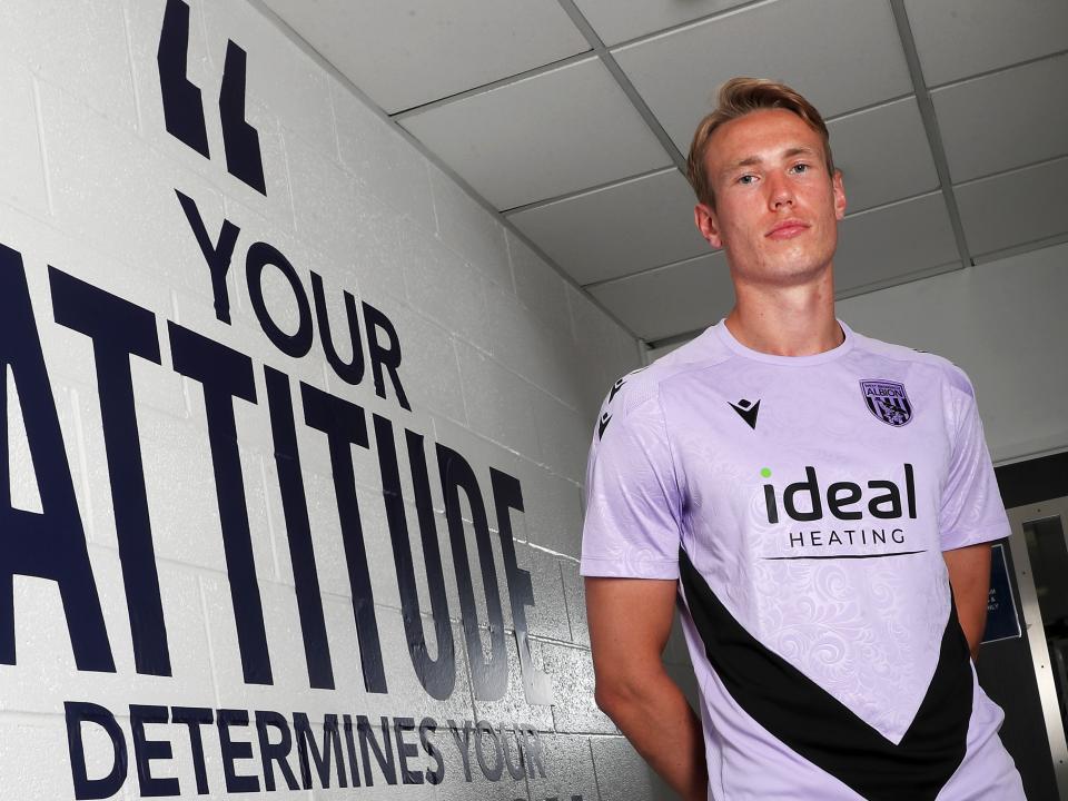 Torbjørn Heggem stood next to a wall with motivational words