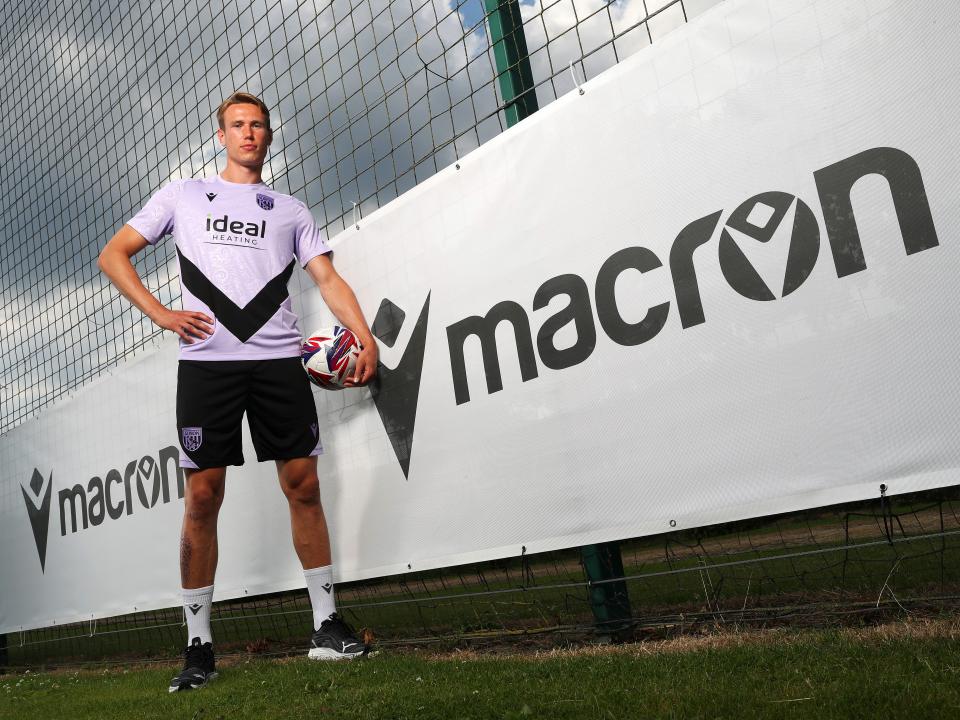 Torbjørn Heggem stood next to a Macron sign at the training ground 