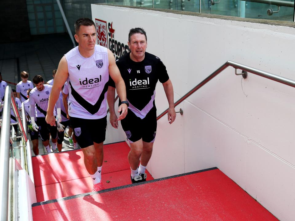 Jed Wallace and Director of Medical Tony Strudwick walking up the steps to the training pitch at St. George's Park