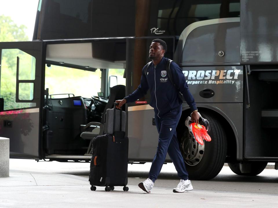 Josh Maja arriving at St. George's Park pushing a suitcase 