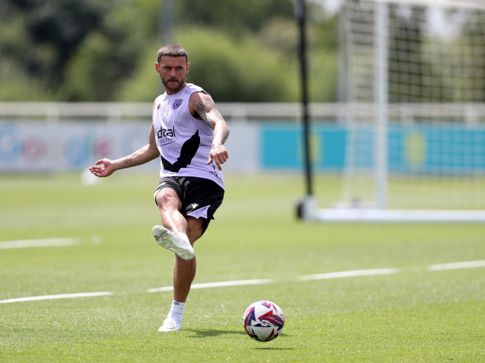 John Swift passing the ball during a training session at St. George's Park