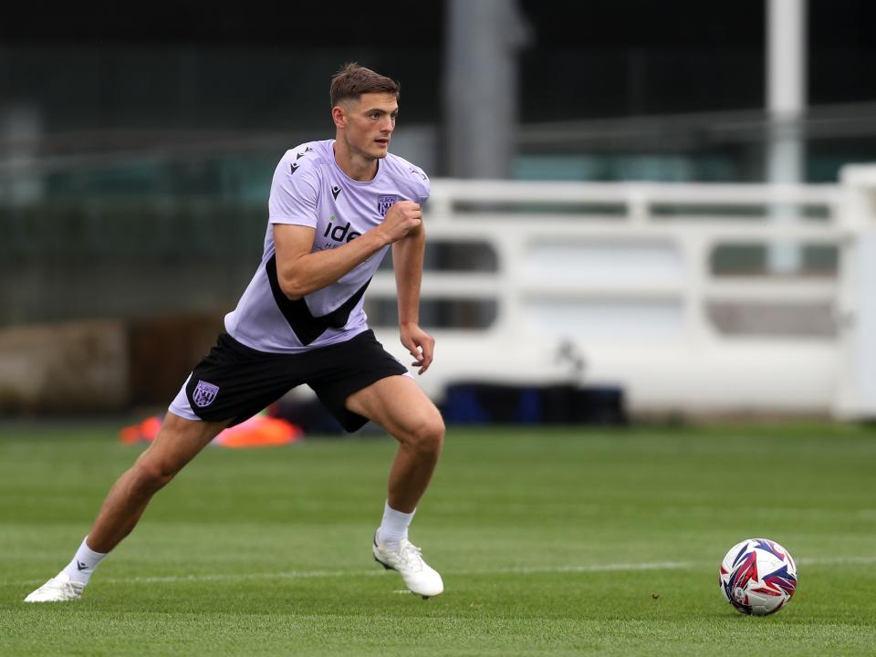 Caleb Taylor running with the ball during a training session at St. George's Park