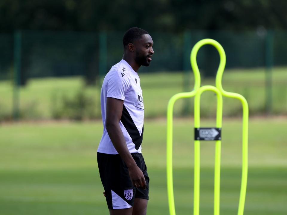 Semi Ajayi stood next to a mannequin during training 