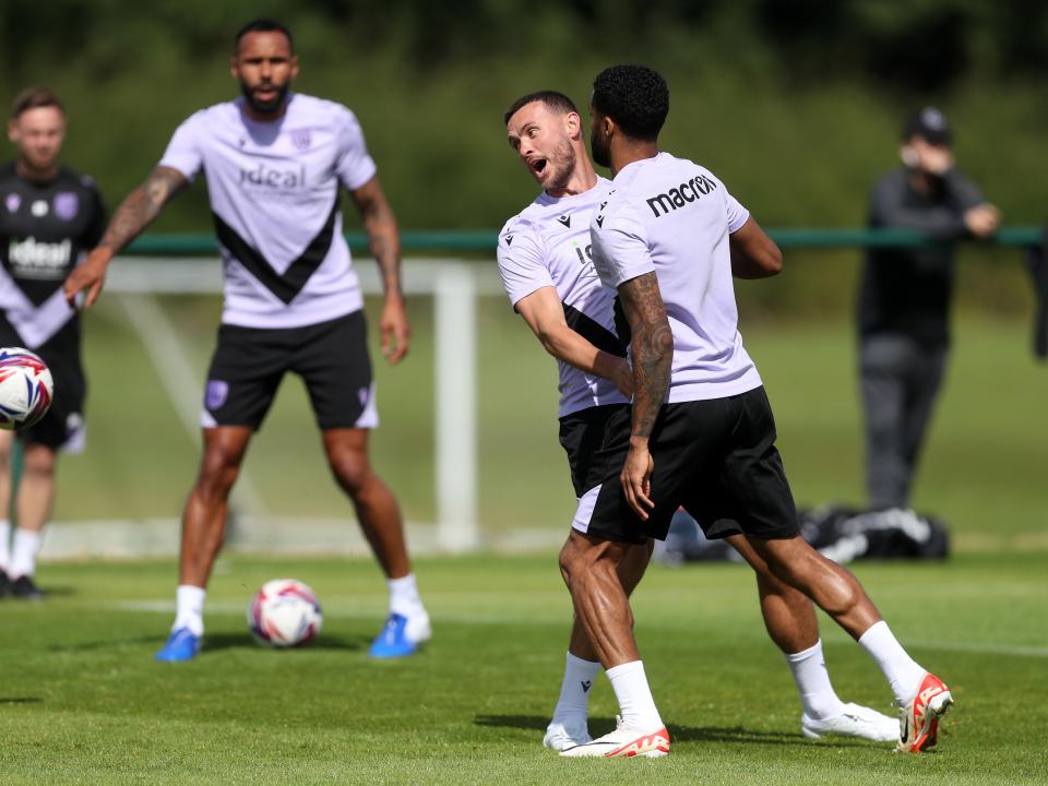 Darnell Furlong and John Swift battling for the ball during training 