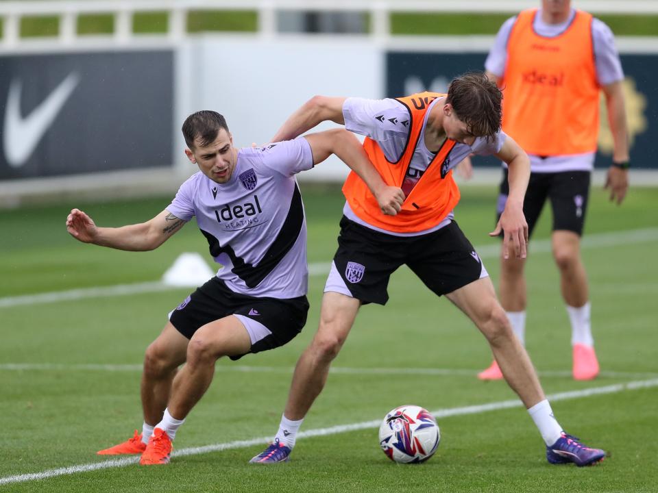 Jayson Molumby and Harry Whitwell fight for the ball during a training session at St. George's Park 