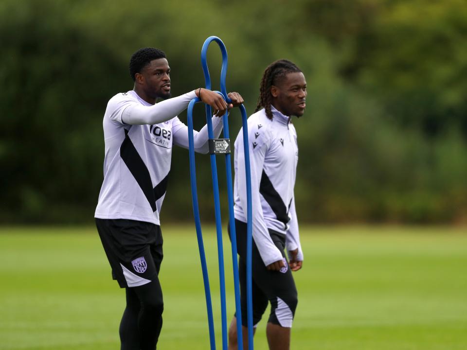 Josh Maja and Brandon Thomas-Asante stood by a mannequin during a training session 