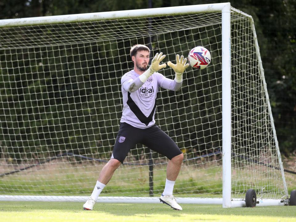 Joe Wildsmith catching the ball during a training session at St. George's Park