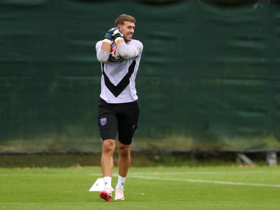 Alex Palmer gripping the ball during a training session 