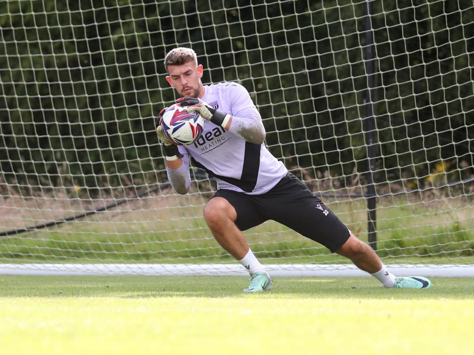 Alex Palmer catching the ball during a training session at St. George's Park