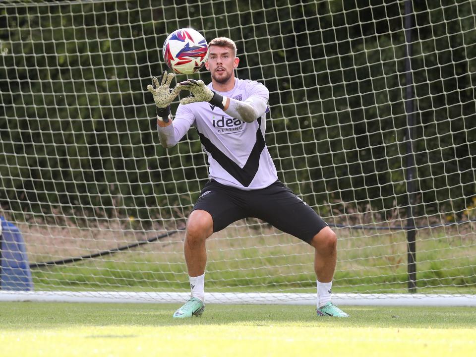 Alex Palmer catching the ball during a training session at St. George's Park