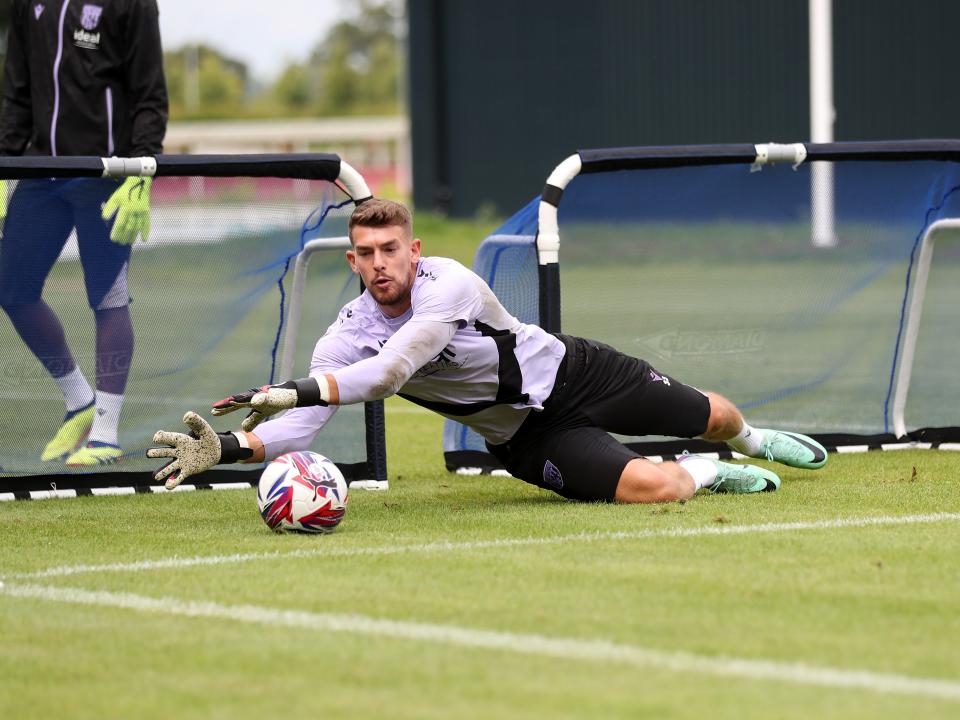 Alex Palmer saving a shot during a training session at St. George's Park