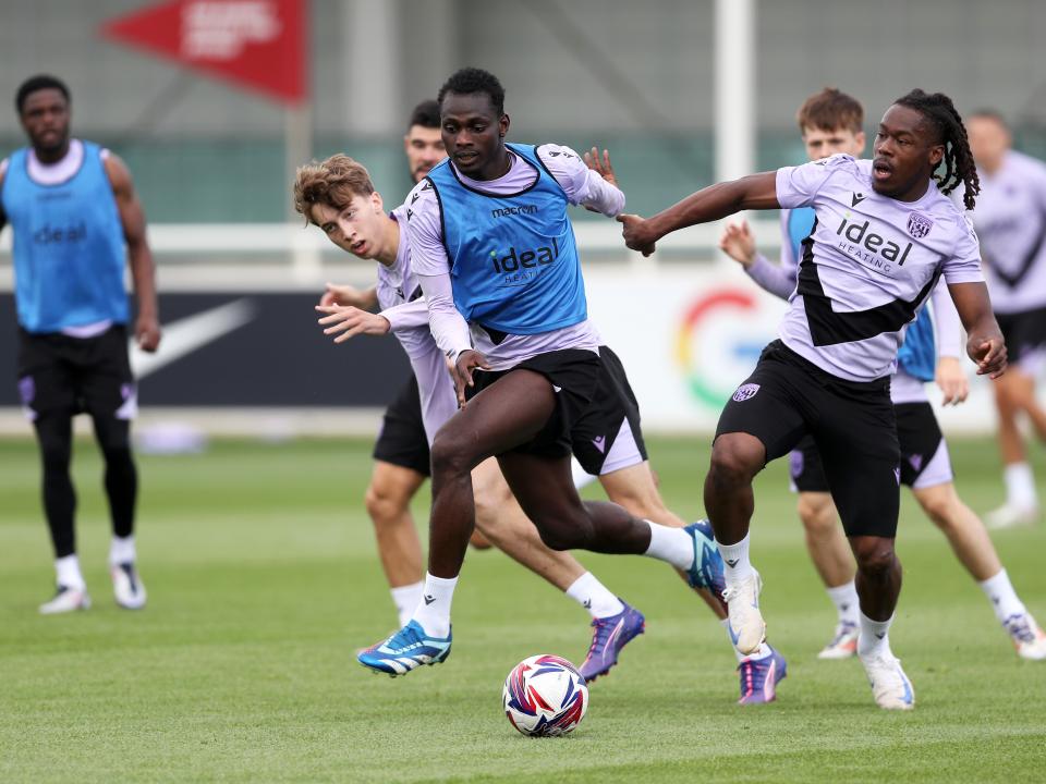 Brandon Thomas-Asante and Ousmane Diakité battle for the ball during training at St. George's Park 