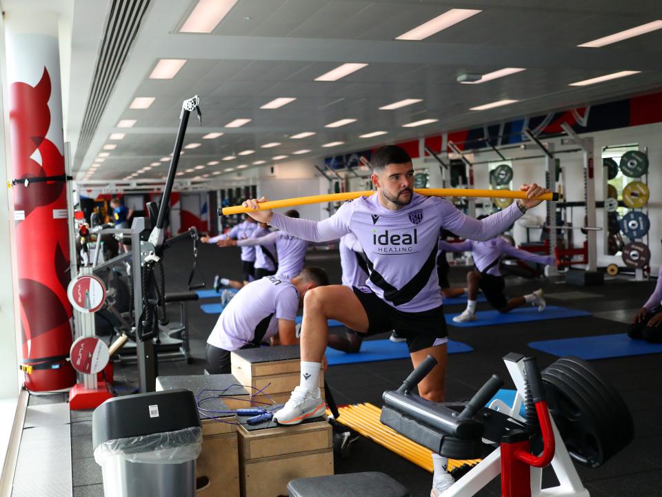 Alex Mowatt stretching in the gym at St. George's Park