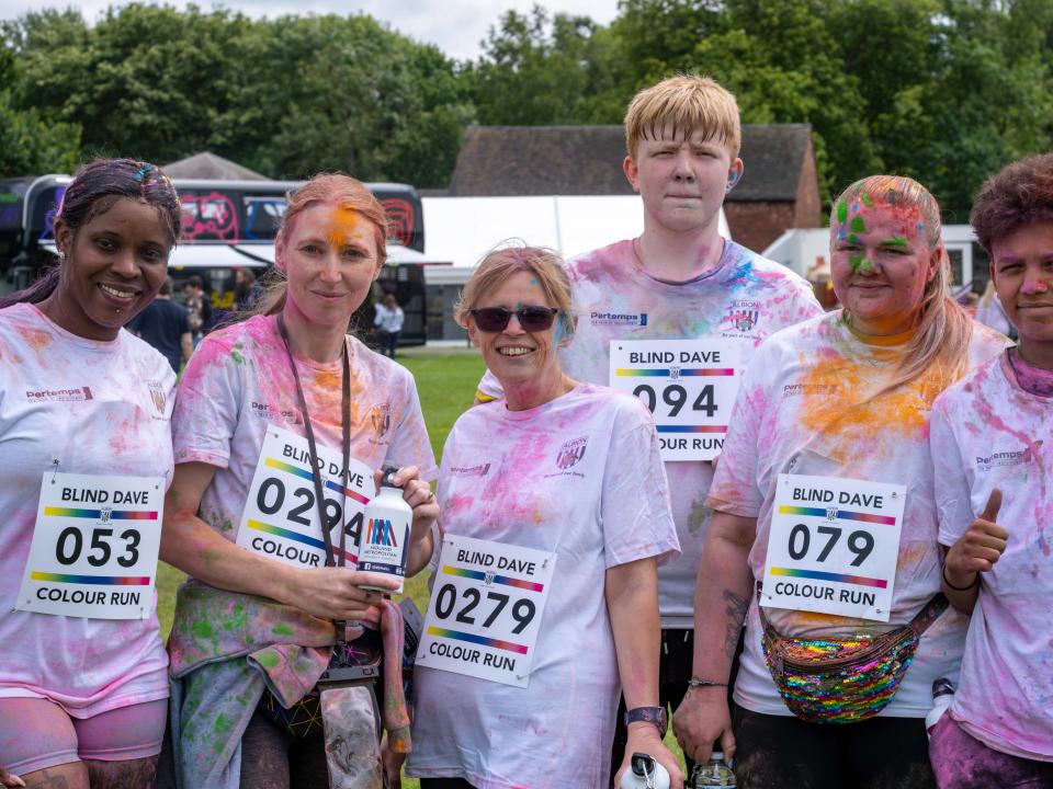 Group of six, posing for photo.