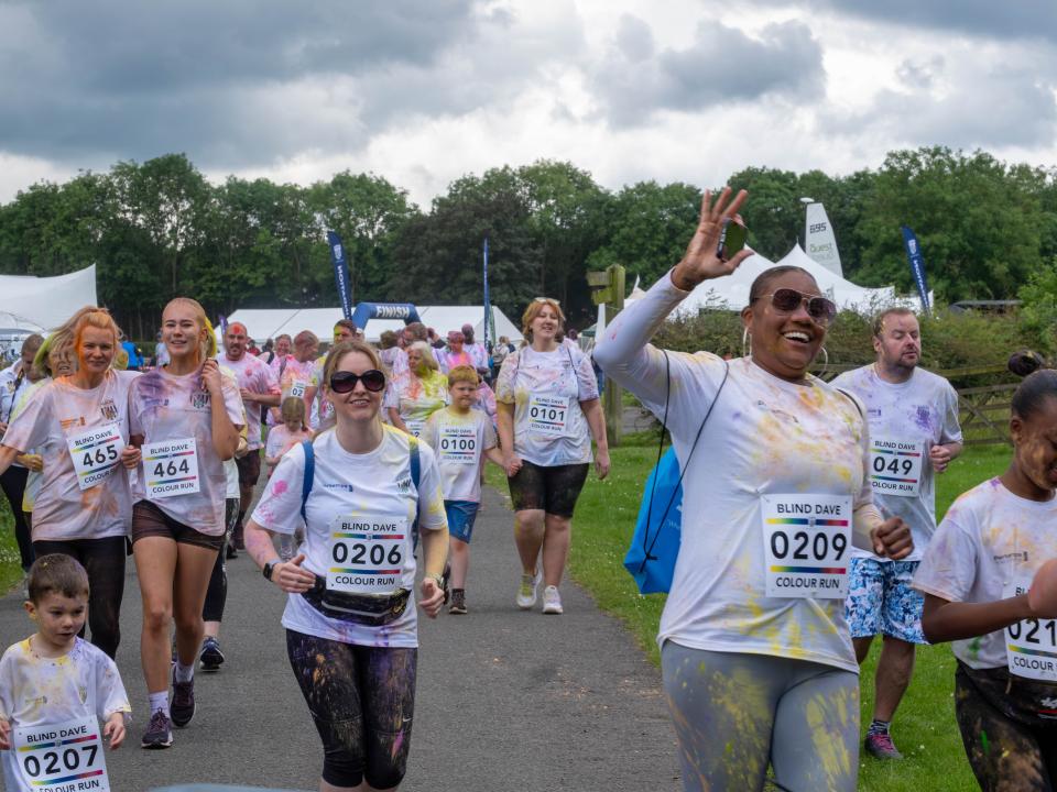 Participants smiling, running the course.