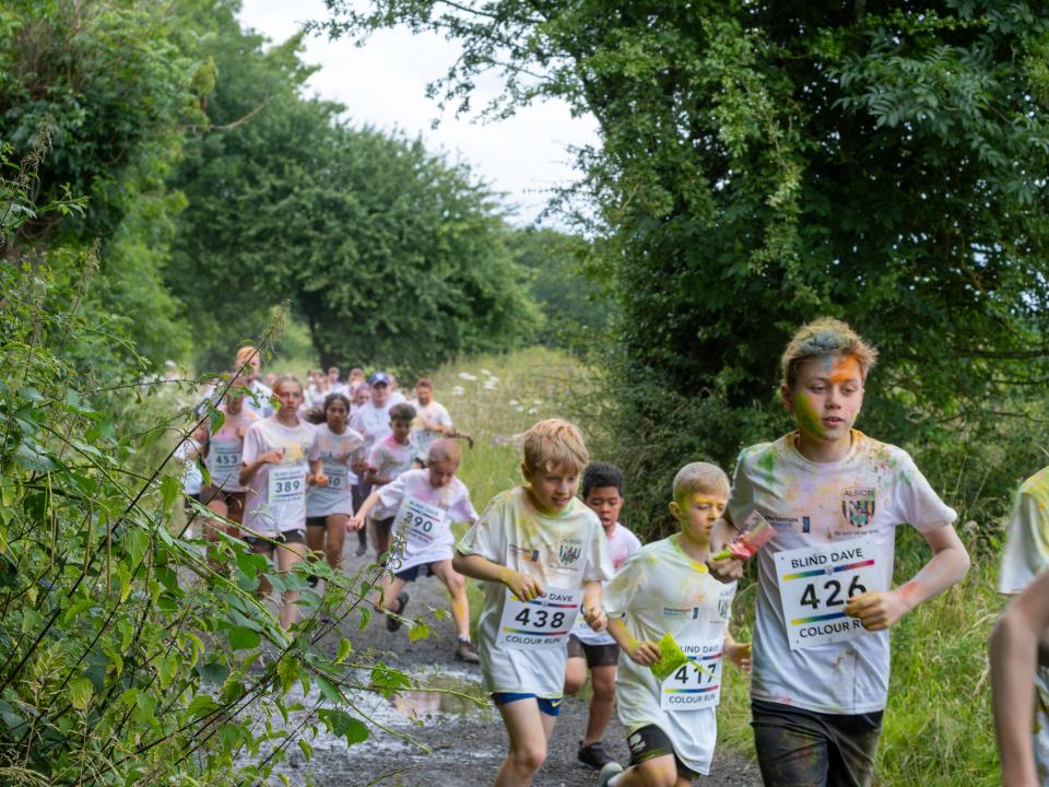 Runners heading through shrubs on Sandwell Valley Park.