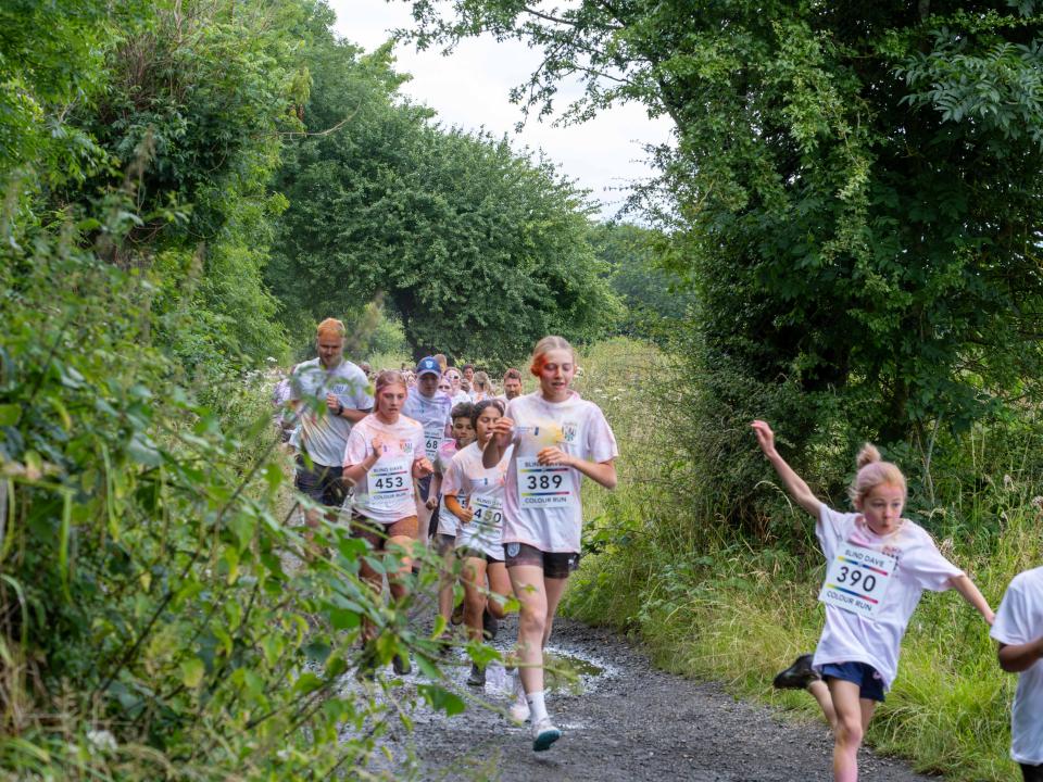 Runners heading through shrubs on Sandwell Valley Park.