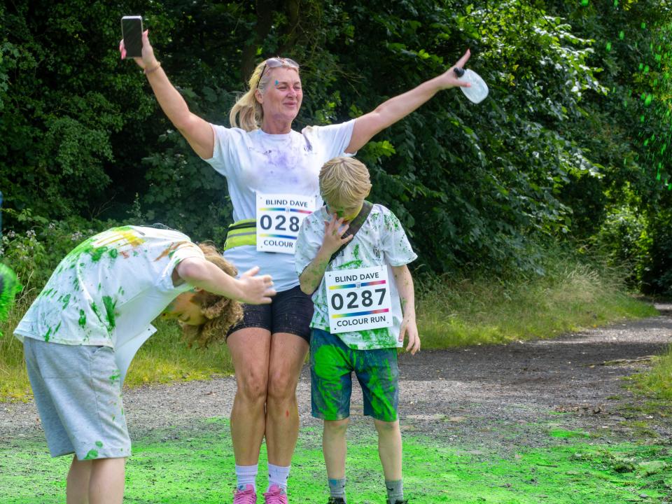 Family of three, being cover with paint powder.