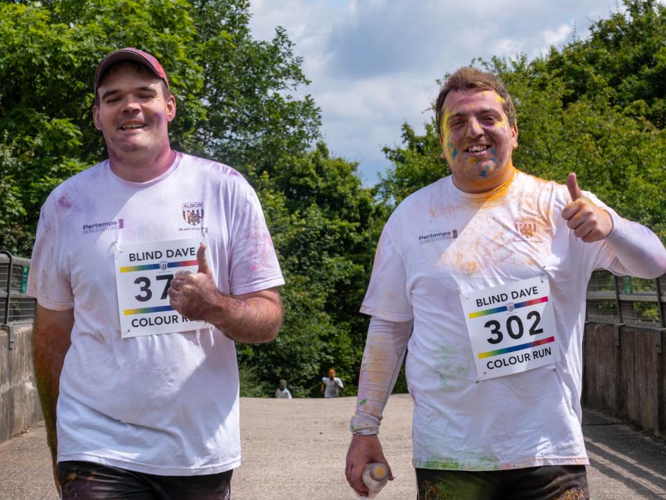 Two participants other giving a thumbs up.