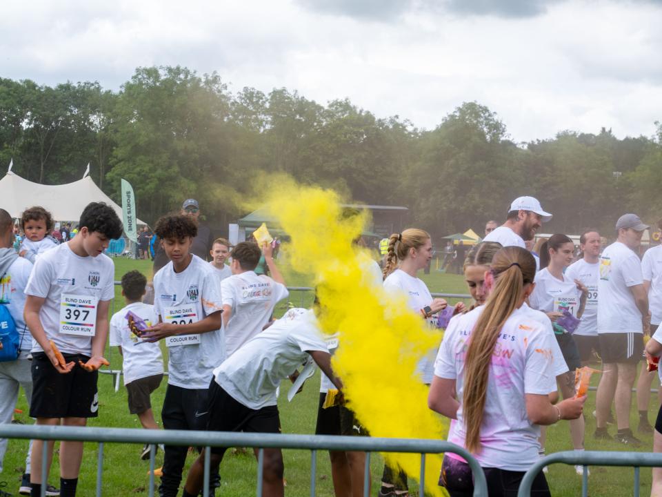 Burst of yellow paint being thrown.