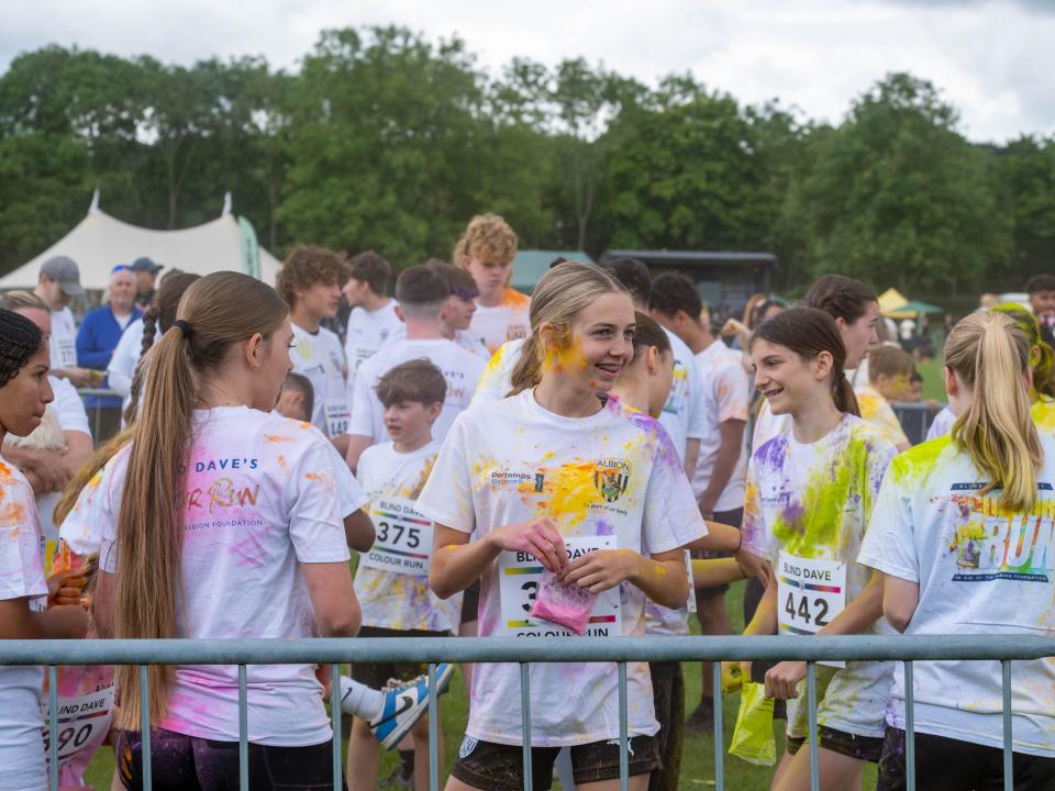 Group of ETC participants inside barrier throwing paint powder.