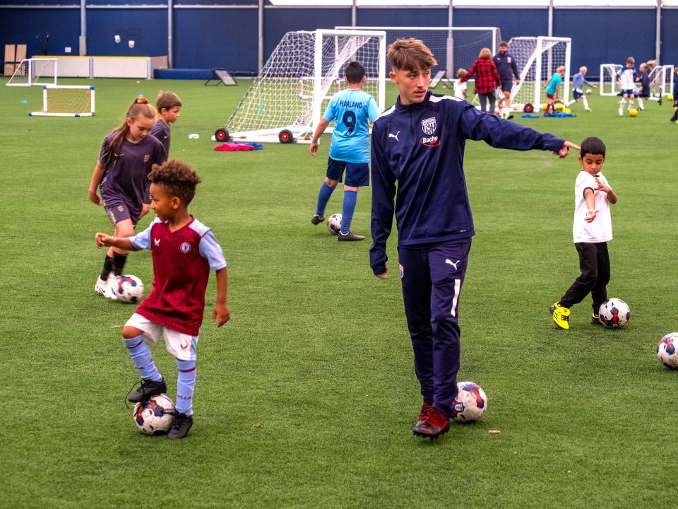 Reece pointing as he gives instructions to youngsters at Pre Academy Festival. 