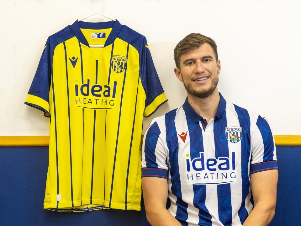 Paddy McNair sat down in the home shirt while the away shirt hangs up next to him 