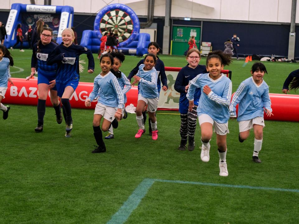 Group of girls running in the WBA Academy Dome