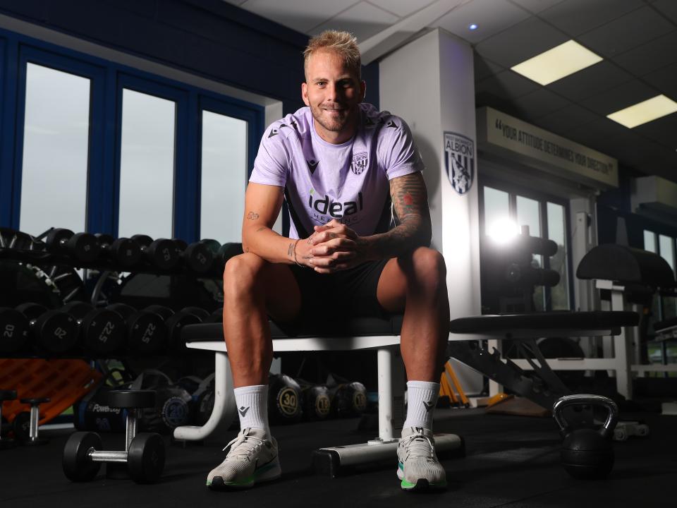 Uroš Račić smiling at the camera while sat in gym 