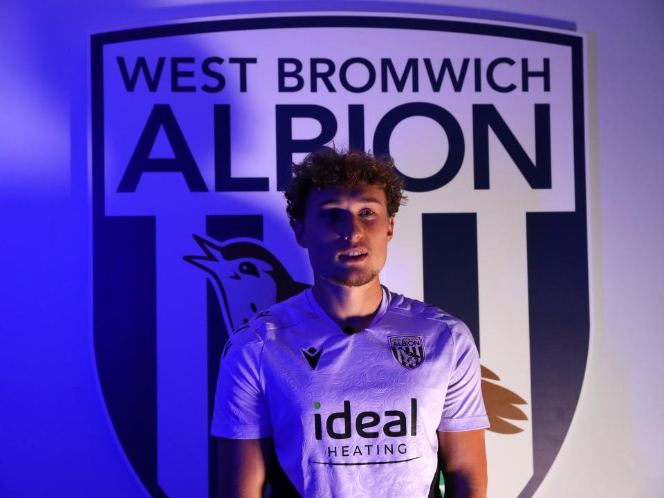 Callum Styles stood in front of a WBA badge 