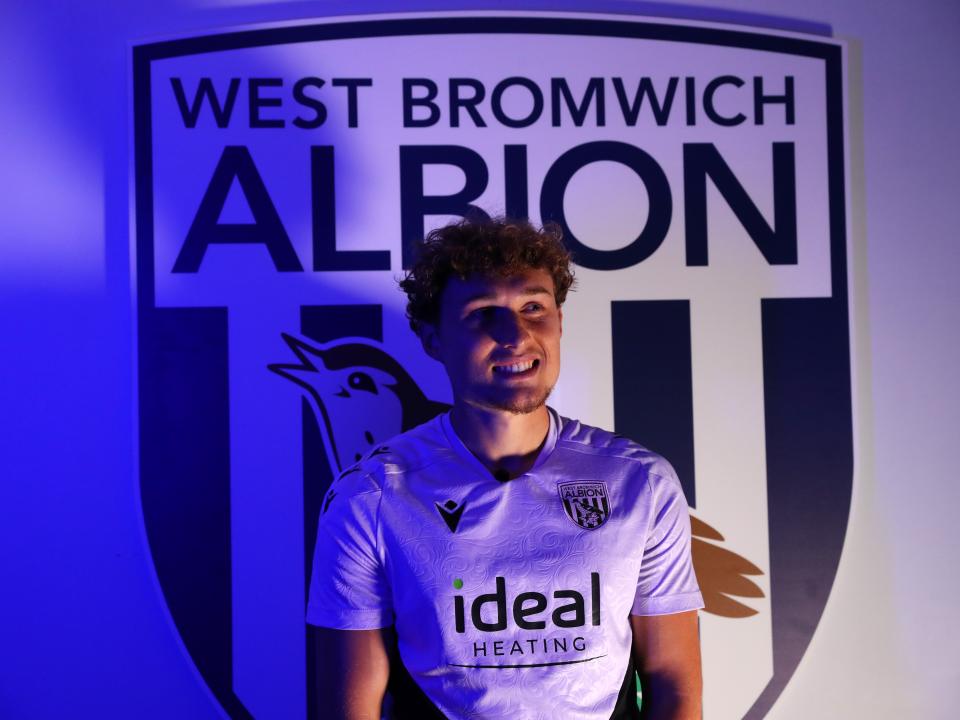 Callum Styles stood in front of a WBA badge 