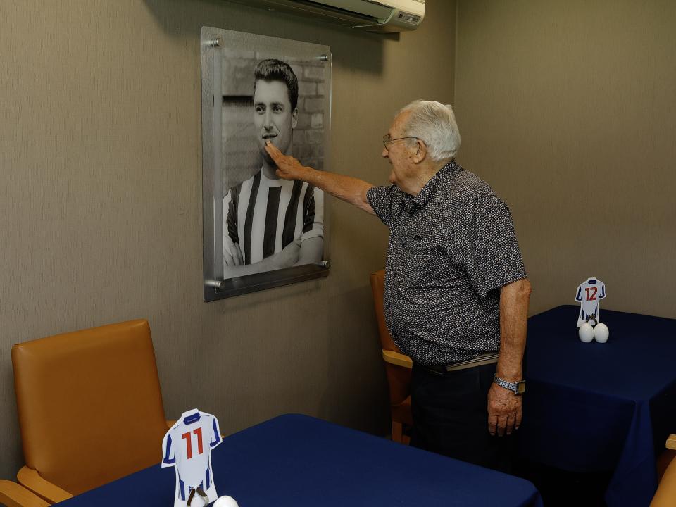 Graham Williams looking at a picture on the wall at The Hawthorns 