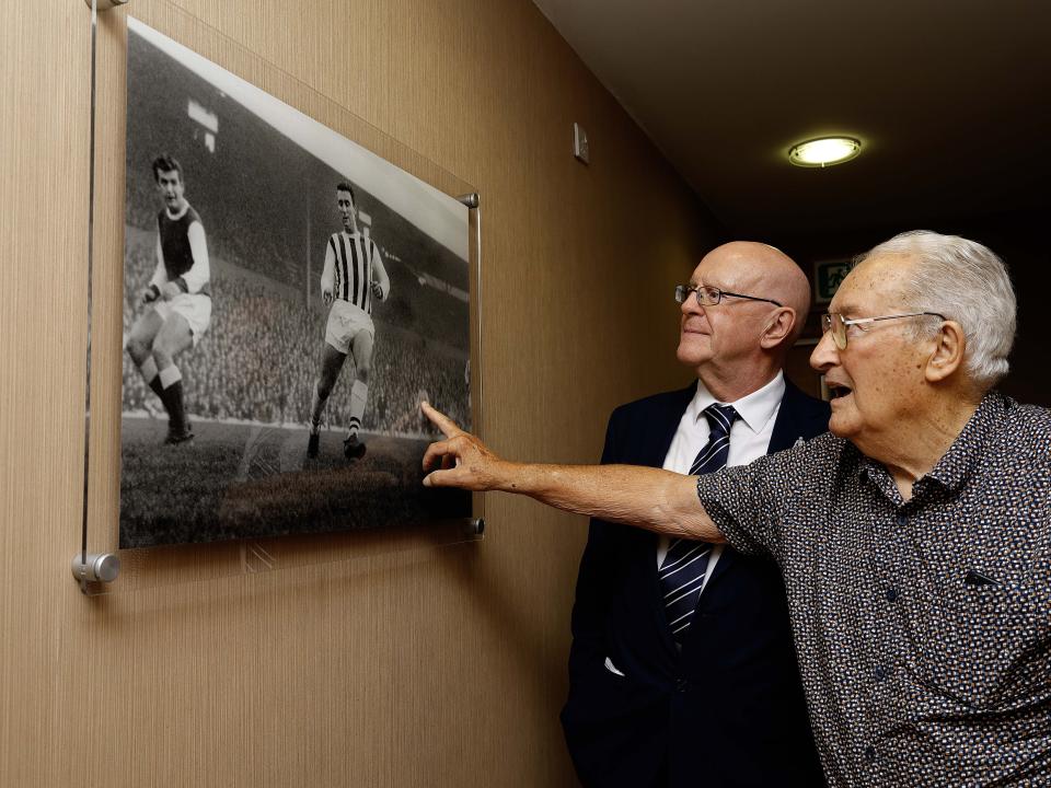 Graham Williams looking at a picture on the wall at The Hawthorns 