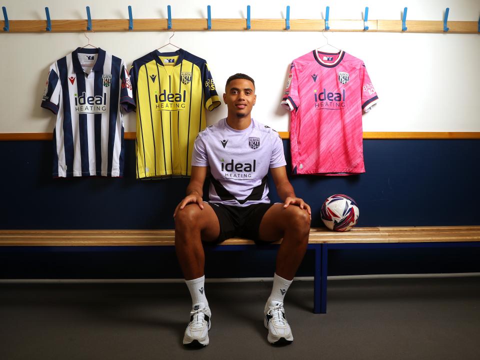 Lewis Dobbin sat in a dressing room surrounded by WBA shirts 