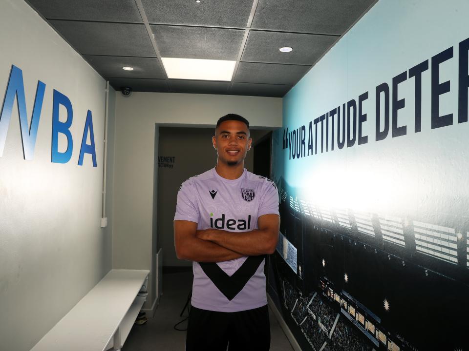 Lewis Dobbin stood in a corridor with his arms folded looking at the camera 