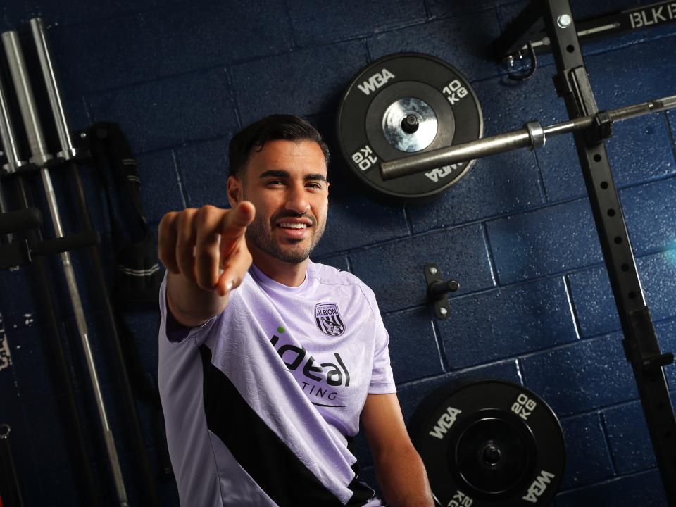 Gianluca Frabotta smiling at the camera while sat in the gym