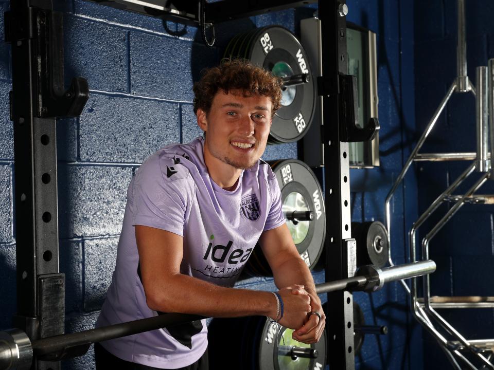 Callum Styles smiling at the camera while stood in the gym