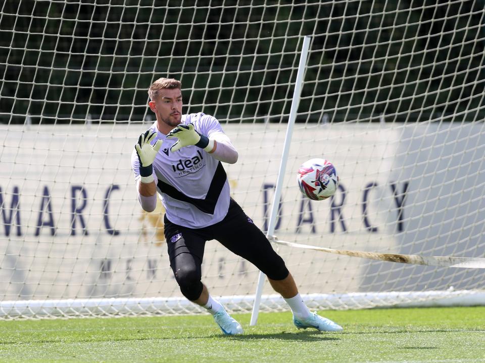 Alex Palmer diving to catch a ball during training 
