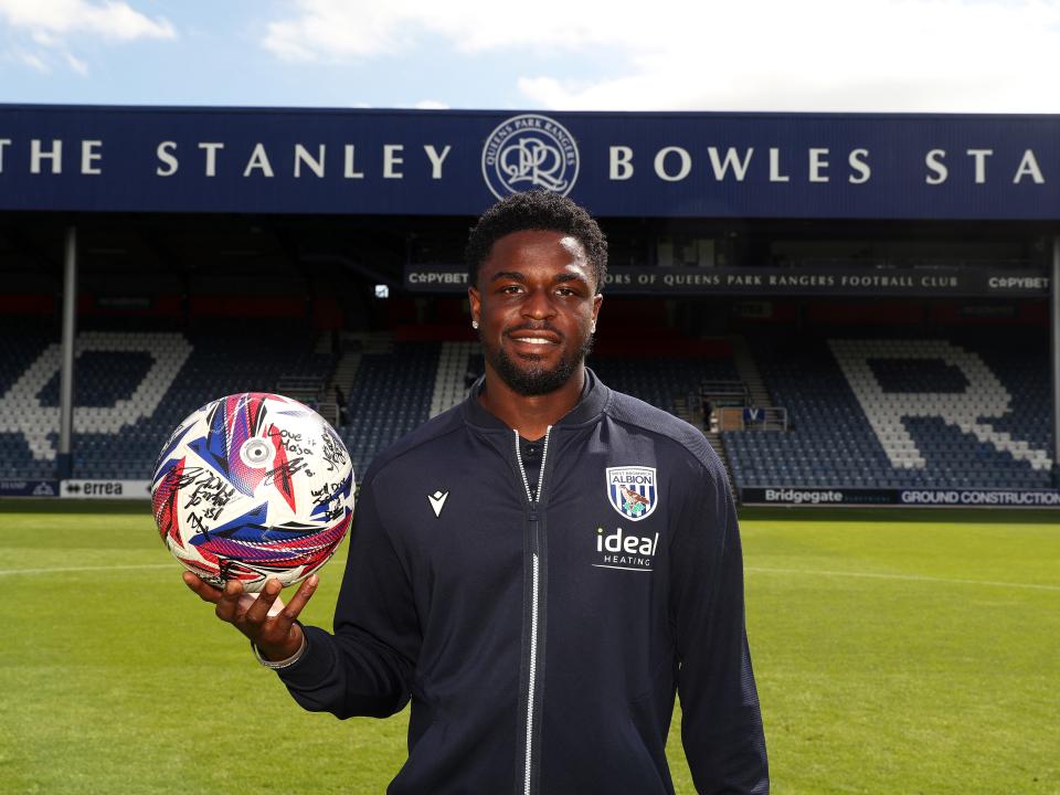 Josh Maja smiling at the camera while holding the match ball at QPR 