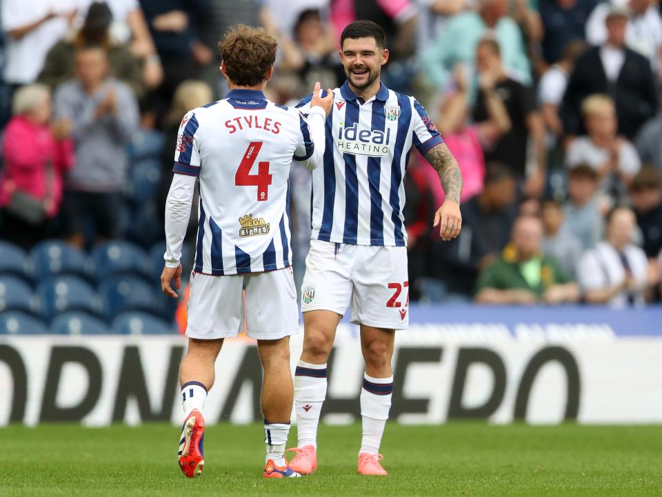 Alex Mowatt and Callum Styles embrace after beating Swansea 