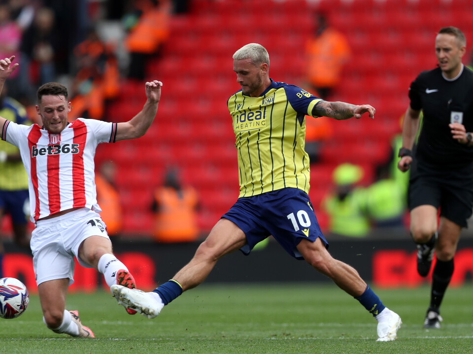 A photo of Albion players in the yellow and blue 2024/25 away kit against Stoke City