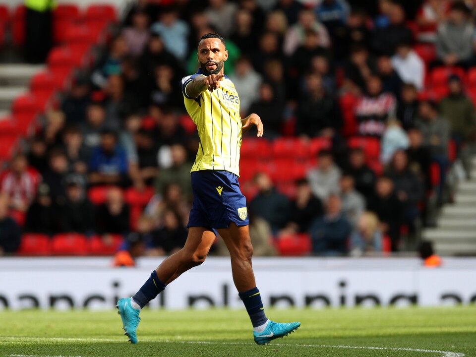 A photo of Albion players in the yellow and blue 2024/25 away kit against Stoke City