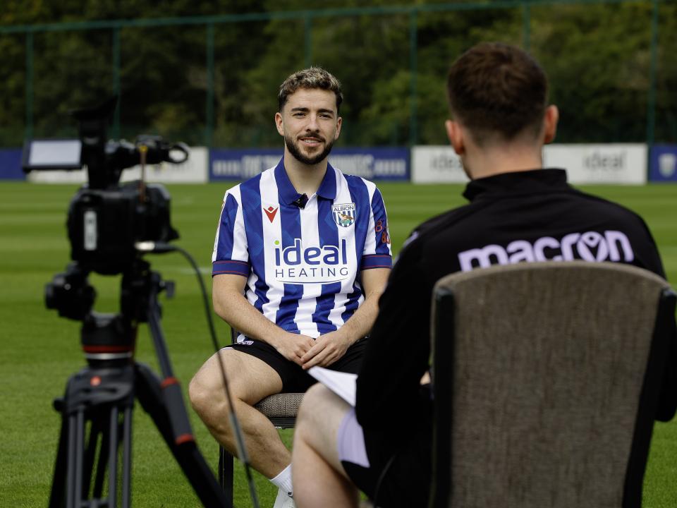 Mikey Johnston sat in a chair on the training pitch being interviewed 