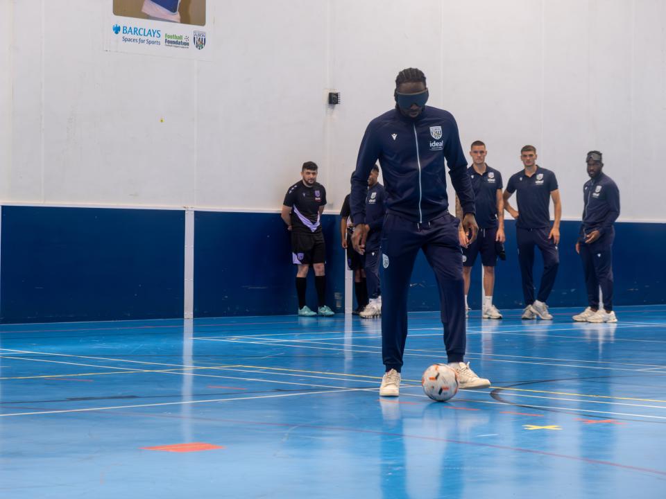 Devante Cole takes part in a blind football session.