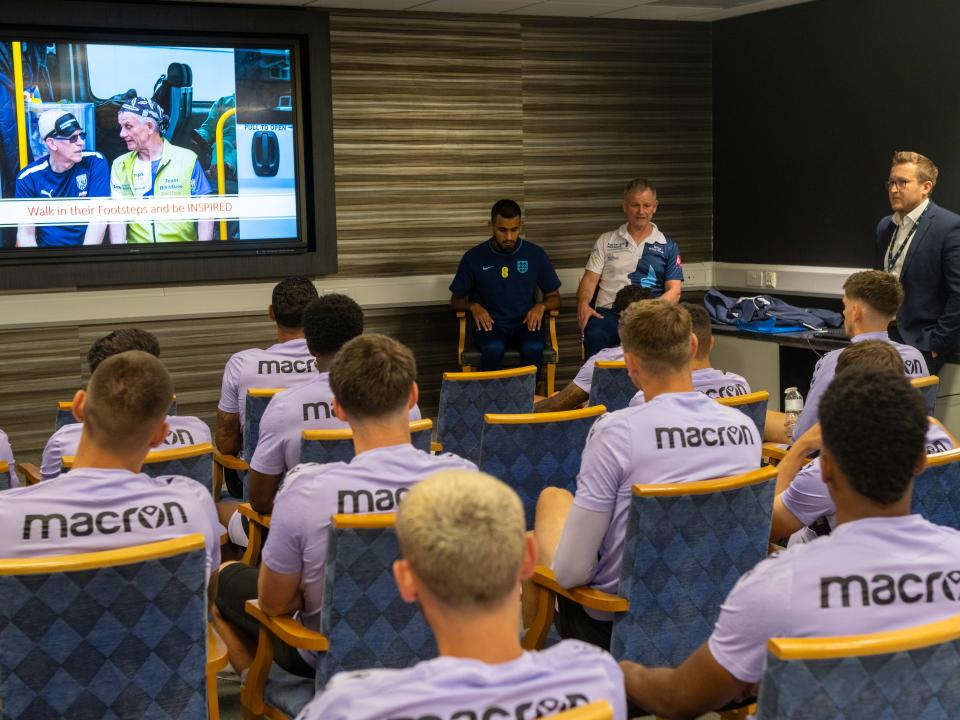 First team players receive a presentation from Rob Lake, "Blind" Dave and Eesa Amjid.