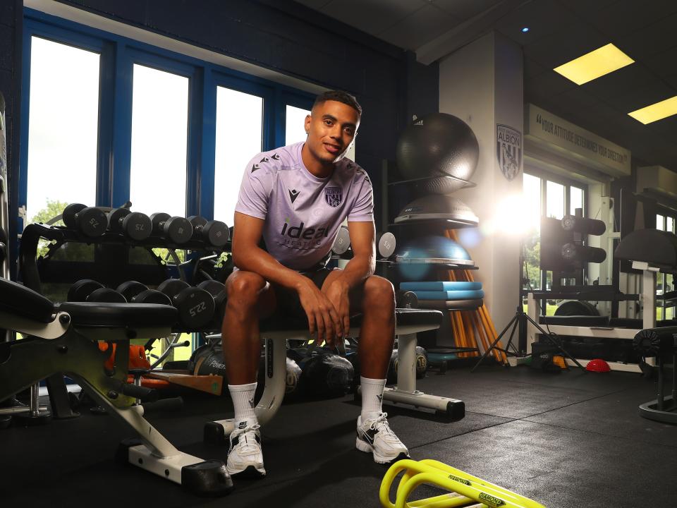 Lewis Dobbin looking at the camera while sat in the gym 