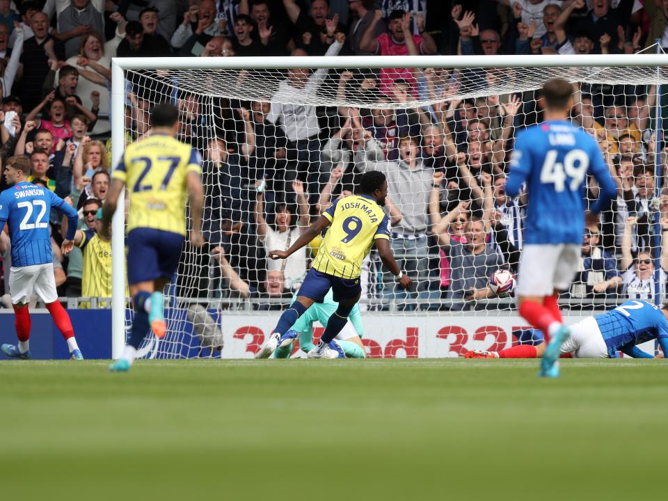 Albion in action against Portsmouth at Fratton Park, in yellow and blue away colours.